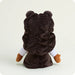 Plush toy with a brown hood and white sleeves on a light gray background