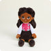 Plush toy of a girl in a varsity jacket with a letter 'B' on a white background