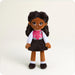Plush toy of a girl in a pink and white jacket with a letter 'B' on a white background
