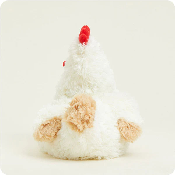 Plush toy chicken with a red comb on a light beige background
