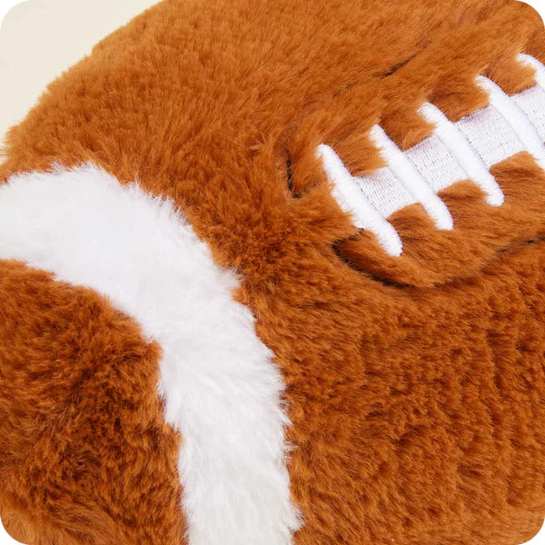 Close-up of a plush football toy with brown and white colors.