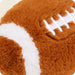 Close-up of a plush football toy with brown and white colors.