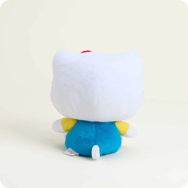 Plush toy with a white face, blue body, and yellow accents on a light beige background