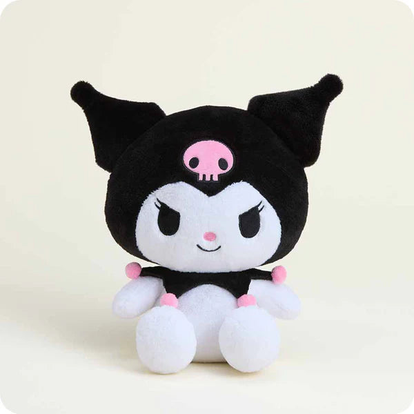 Plush toy with black and white design and pink accents on a light beige background