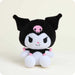 Plush toy with black and white design and pink accents on a light beige background
