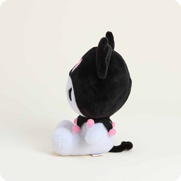 Black and white plush toy with pink accents on a light beige background