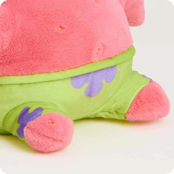 Close-up of a colorful plush toy with pink top and green body on a white background