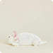 White rabbit plush toy on a beige background