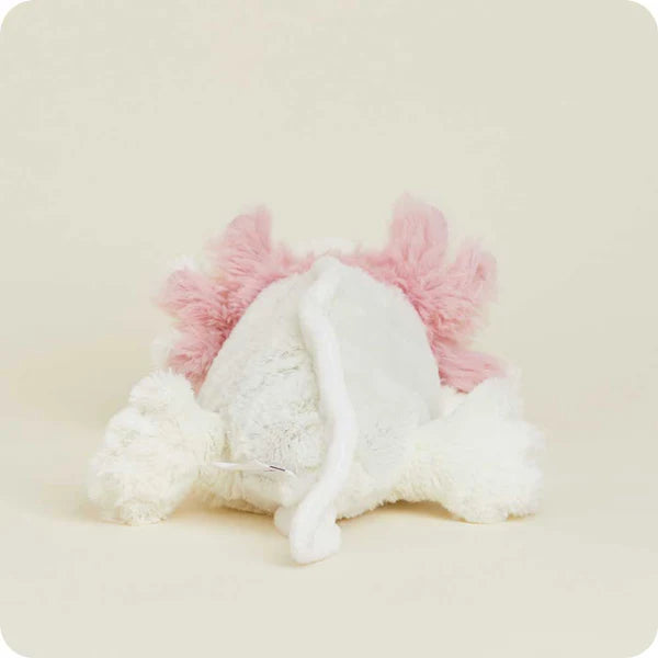 White plush toy with pink accents on a beige background