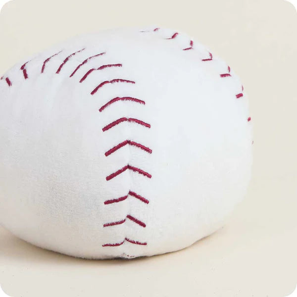 White plush toy resembling a baseball with red stitching on a beige background
