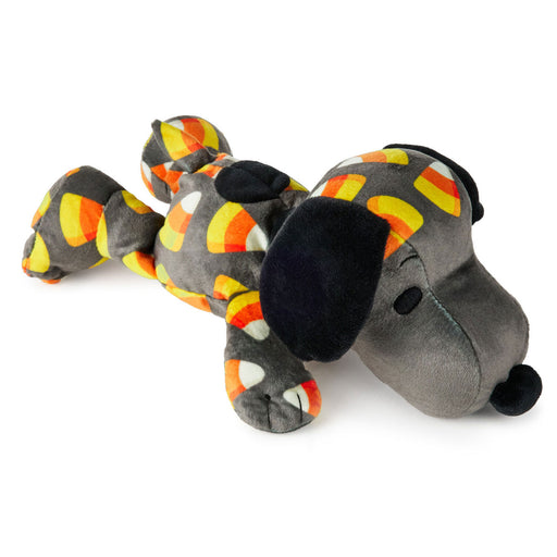A plush dog toy styled like Snoopy, lying down on a white background. The toy is gray with black ears, nose, and eyes, and has orange, yellow, and white candy corn patterns on its body.
