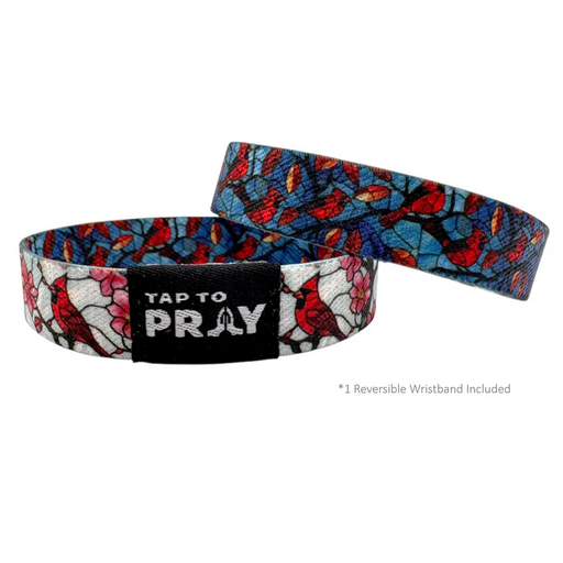 Reversible wristband with bird pattern and 'Tap to Pray' text on a white background