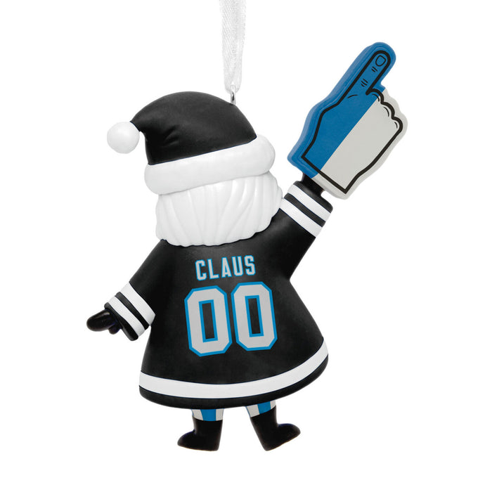 A personalized Christmas ornament shaped like Santa Claus from behind, wearing a black hockey jersey with the name 'CLAUS' and number '00' in light blue, a black Santa hat with white trim, and holding a blue and white foam finger.
