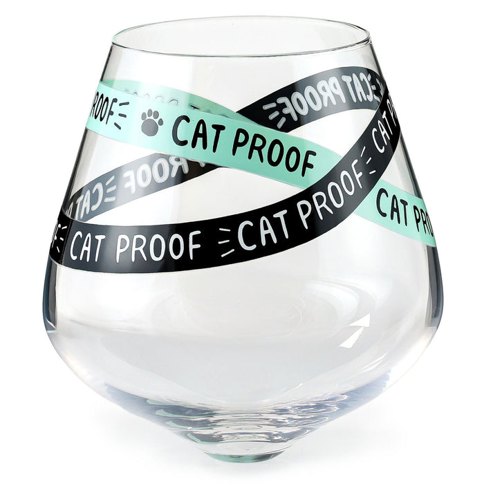 Clear glass with 'Cat Proof' tape around it on a white background