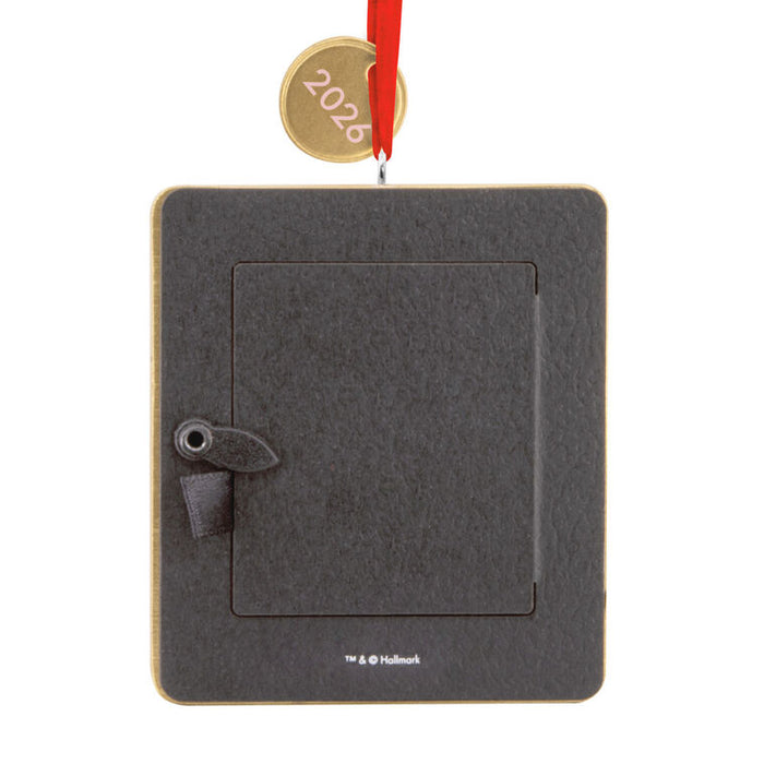 Black square ornament with a red ribbon on a white background