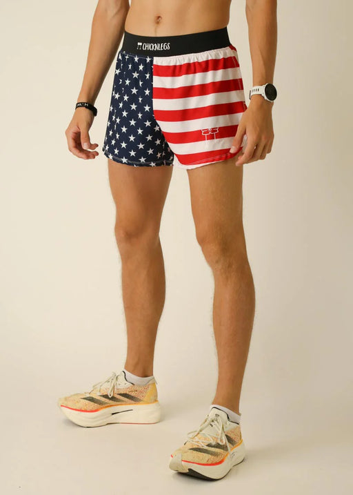 Person wearing American flag shorts on a plain background