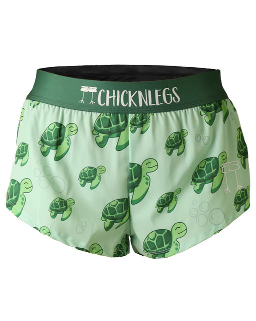 Green shorts with turtle pattern and 'CHICKNLEGS' branding on a white background