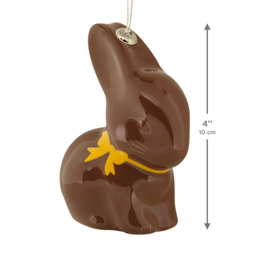 Chocolate bunny with a yellow bow tie and measurement details on a white background
