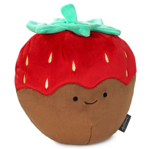 Plush toy shaped like a strawberry with a smiling face on a white background