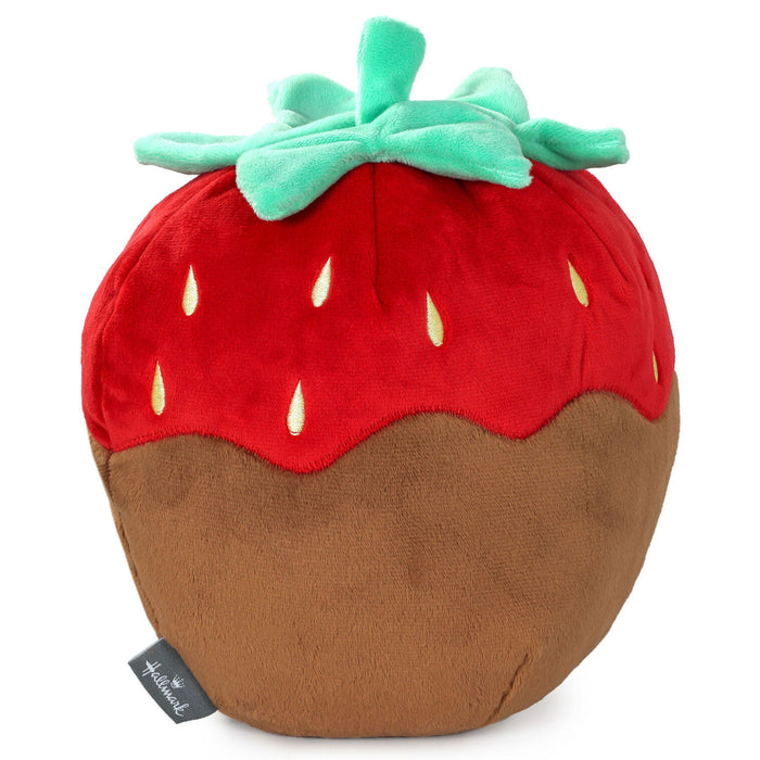 Plush toy shaped like a strawberry with a brown base on a white background