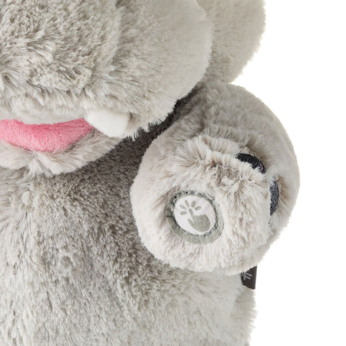 Close-up of a plush elephant toy with a visible brand logo on a white background