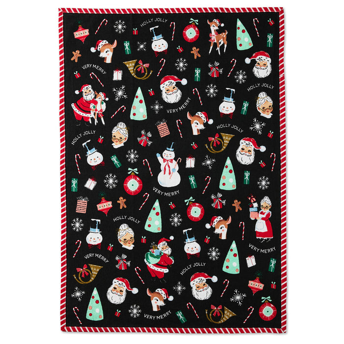 Christmas-themed tea towel with festive designs on a black background