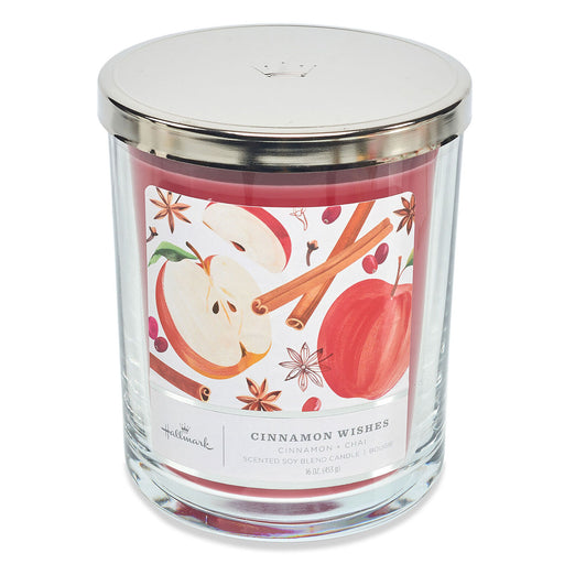 Candle jar with apple and cinnamon design on a white background