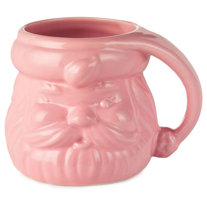 Pink ceramic mug shaped like a face with a handle on a white background