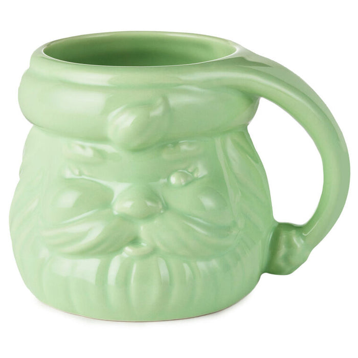 Green ceramic mug shaped like a face with a bow tie on a white background