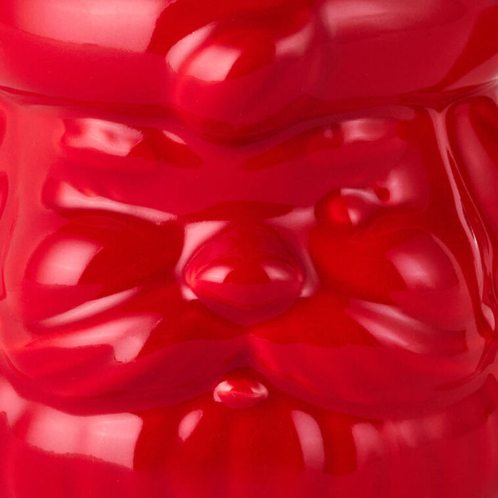 Close-up of a red gummy bear with a glossy texture.