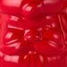 Close-up of a red gummy bear with a glossy texture.