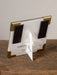 Small photo frame with gold accents on a wooden surface