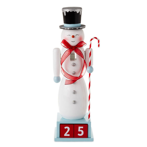 Decorative snowman figurine with a top hat, red scarf, and candy cane on a white background
