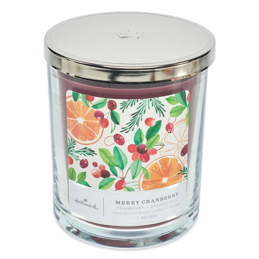Candle jar with a decorative label featuring fruits and leaves on a white background