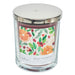 Candle jar with a decorative label featuring fruits and leaves on a white background