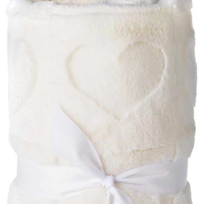 White fleece blanket with a heart design and white ribbon on a white background