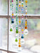 Colorful beaded hanging decoration in front of a window