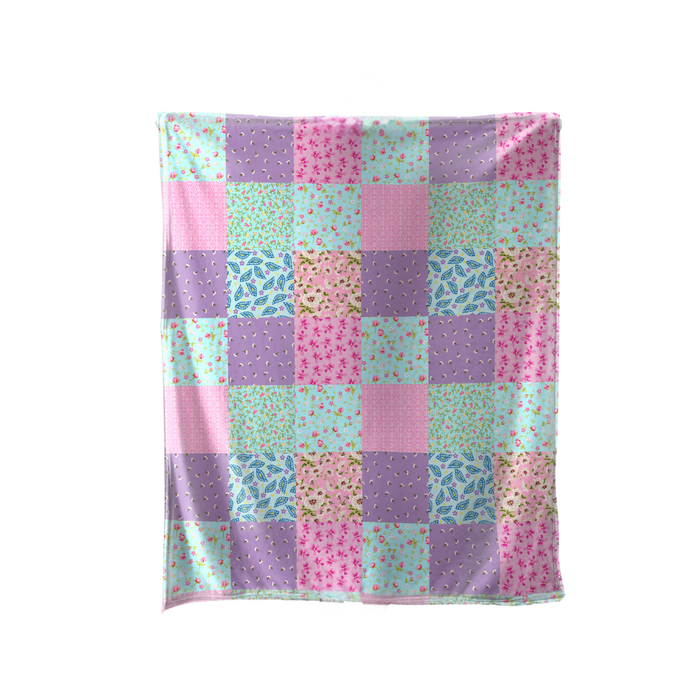 Patchwork blanket with pastel colors on a white background