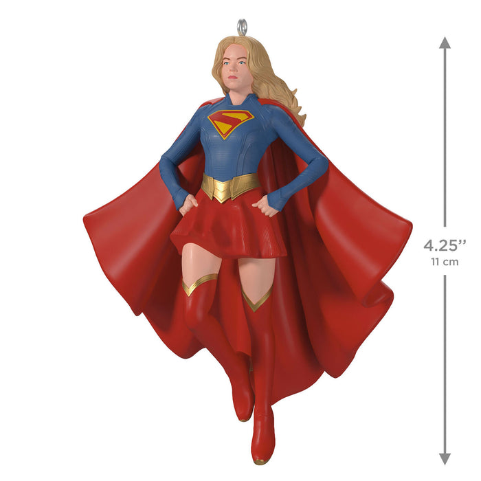 Supergirl figurine with red cape and blue suit on a white background