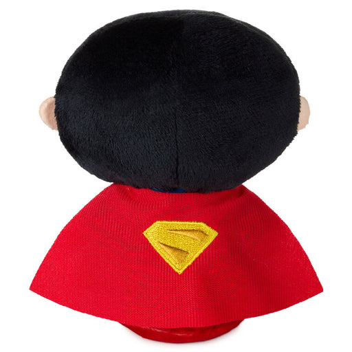 Plush toy with a red cape and yellow Superman logo on a white background