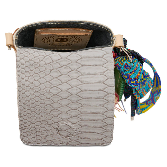Small bag with snake skin pattern and colorful strap on a white background