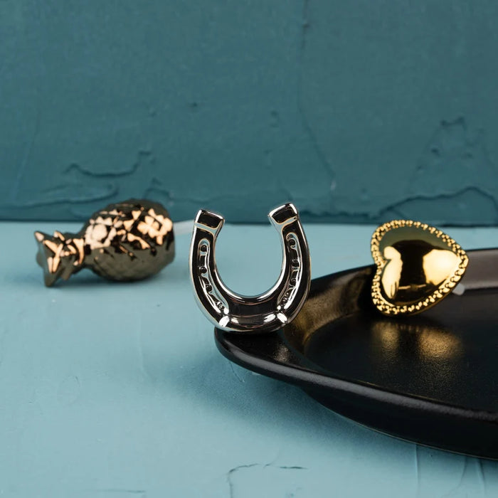 Three specialty minis, luxe lucky in luminous silver, luxe hospitality in warm bronze, and luxe love in radiant gold
