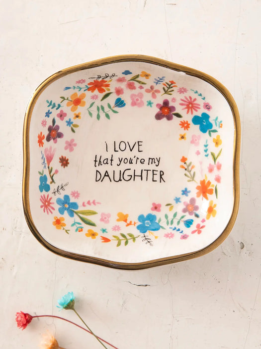 Decorative plate with floral design and text on a light background