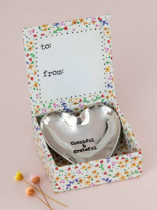 Heart-shaped silver trinket dish in a decorative box with 'thankful, grateful' text on a pink background.