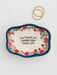 Decorative tray with floral design and text on a white background