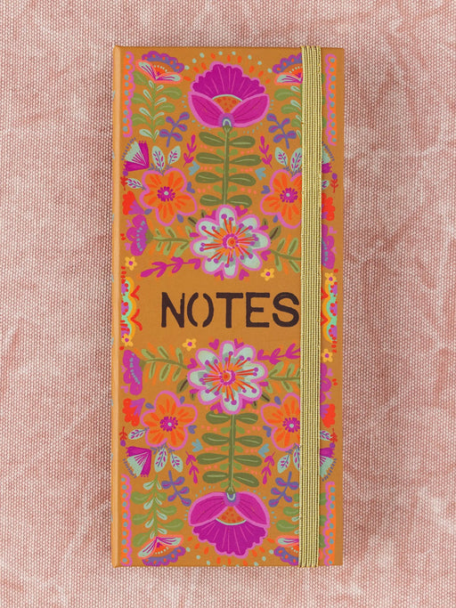Notebook with floral design and 'NOTES' text on a pink background