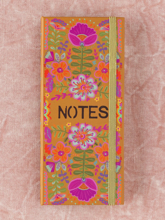 Notebook with floral design and 'NOTES' text on a pink background