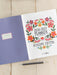 2026-2027 planner with floral design on a wooden surface