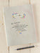 Notebook with motivational quote and floral design on a wooden surface