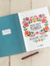 2026-2027 planner with floral design on a wooden surface